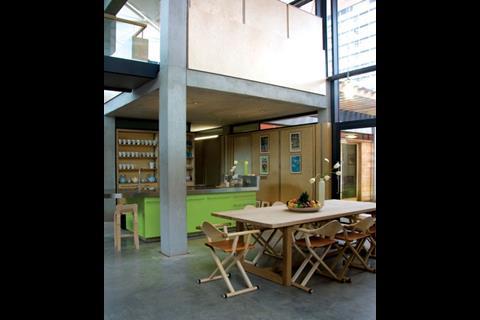A double-height dining space makes up the reassuring heart of London's Maggie’s Centre. The glowering hospital is almost entirely screened from view.